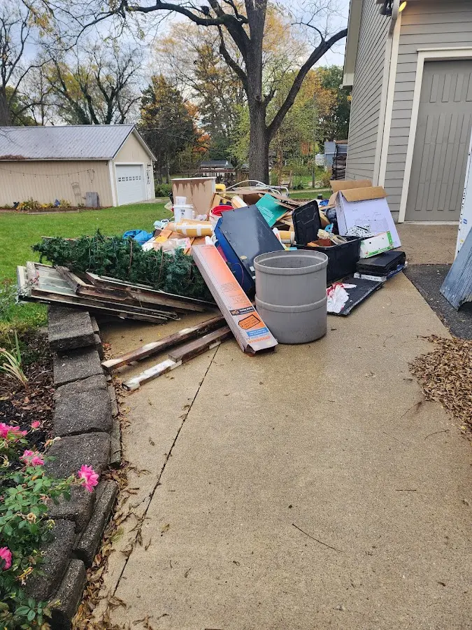 Dumpster being loaded with debris for 12 Yard Dumpster Rental in Elm Grove